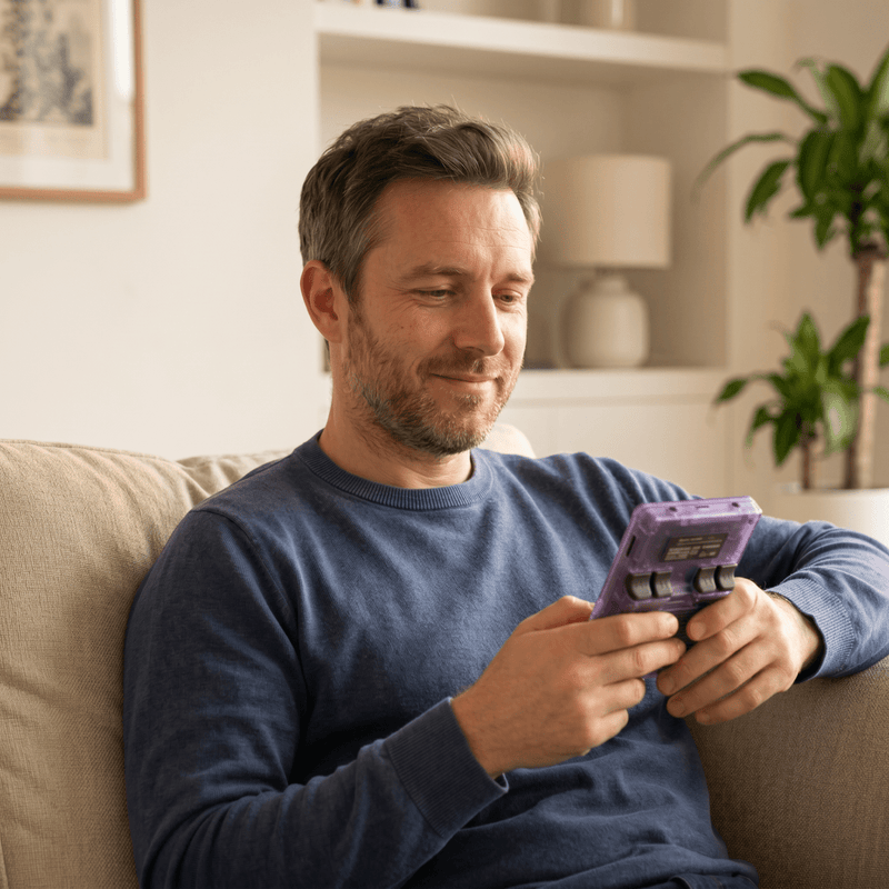 Person playing the Cardcake Pro 2.0 R36S retro gaming console at home